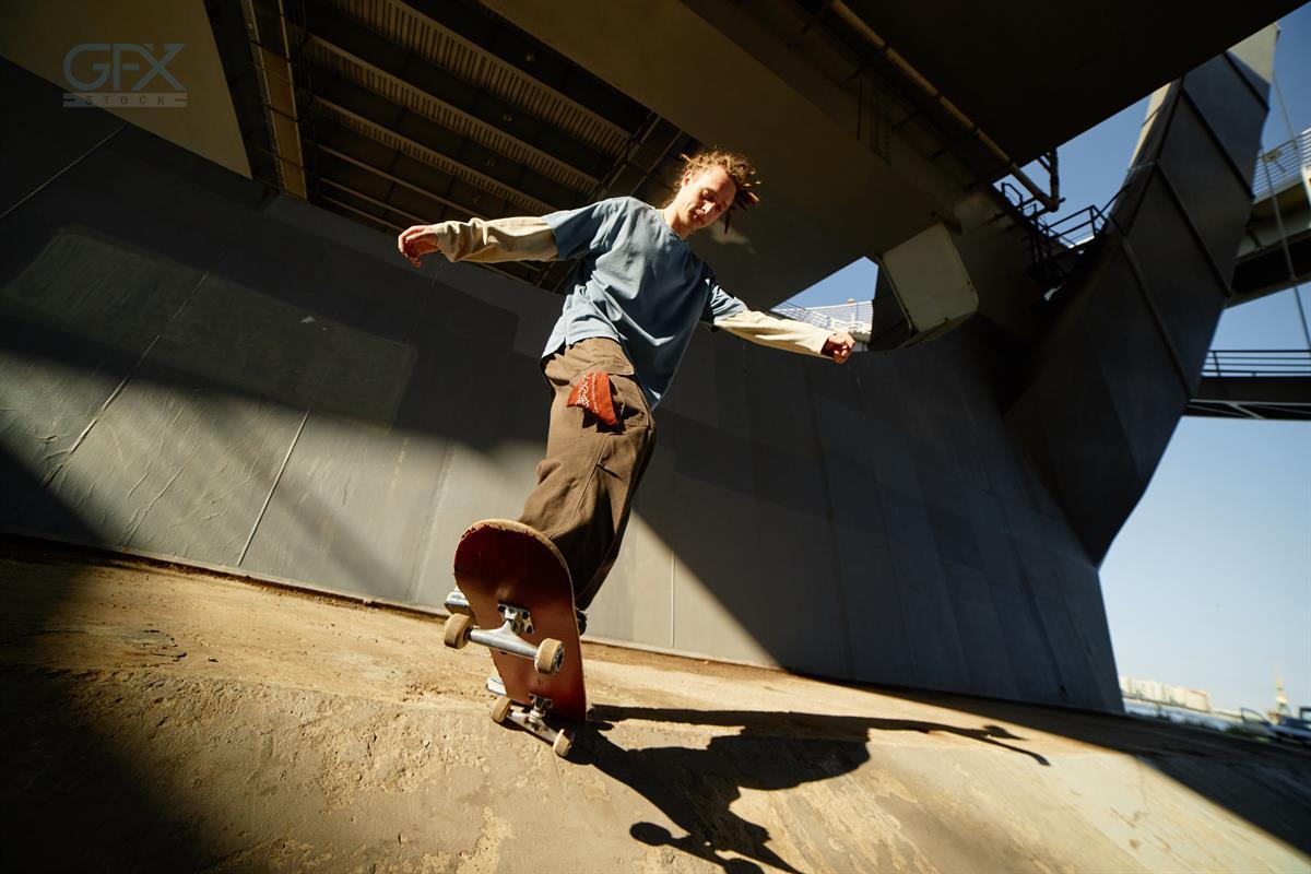 Skateboarding in Urban Environment Under Overpass