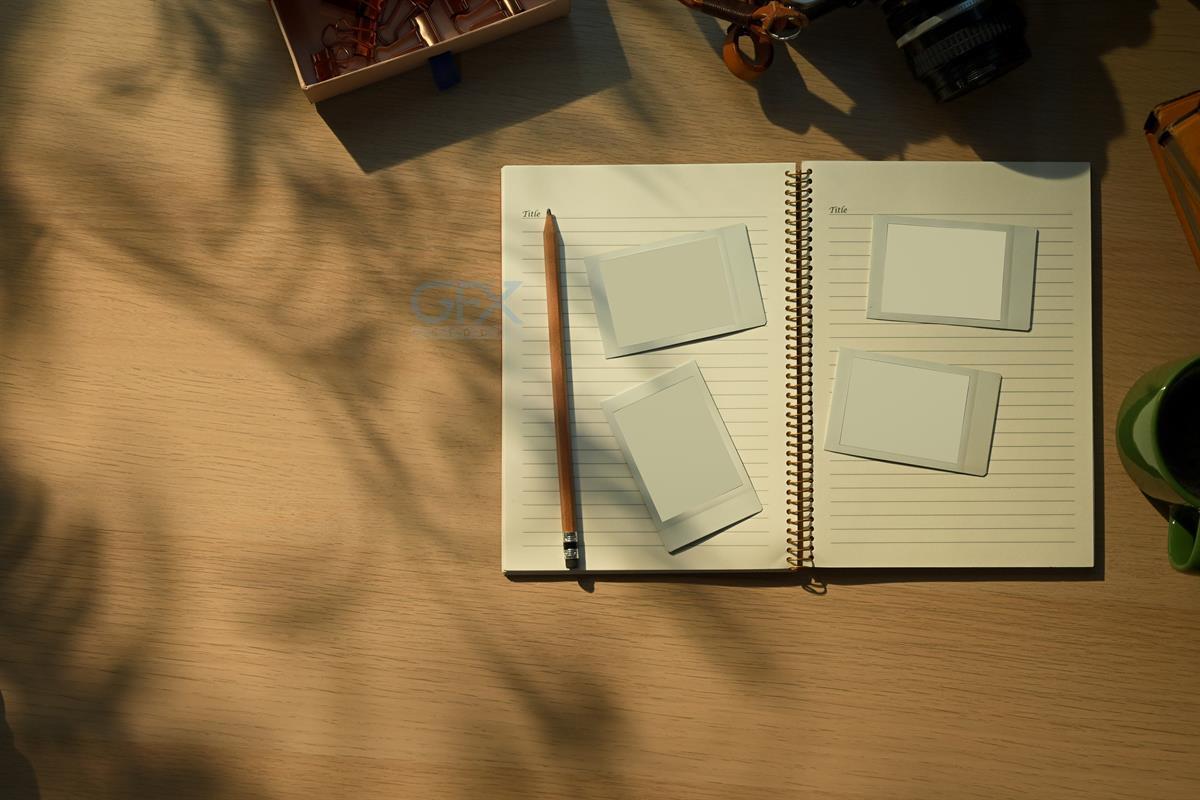 دانلود تصویر موکاپ Creative workspace with vintage camera, notebook, and coffee cup in warm morning sunlight نسخه اصلی برای طراحی گرافیک و برندسازی